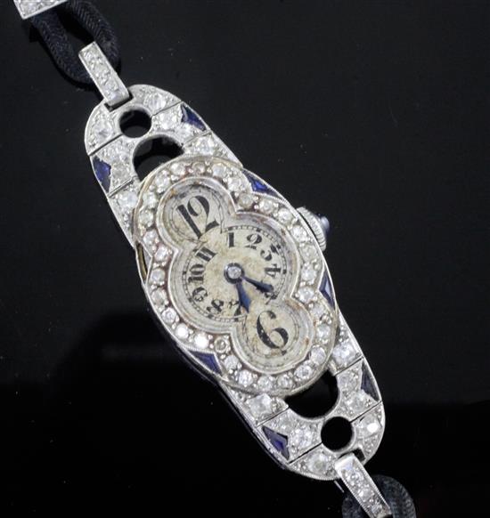 A stylish 1930s Art Deco French platinum, diamond and synthetic? sapphire set oval cocktail watch,
